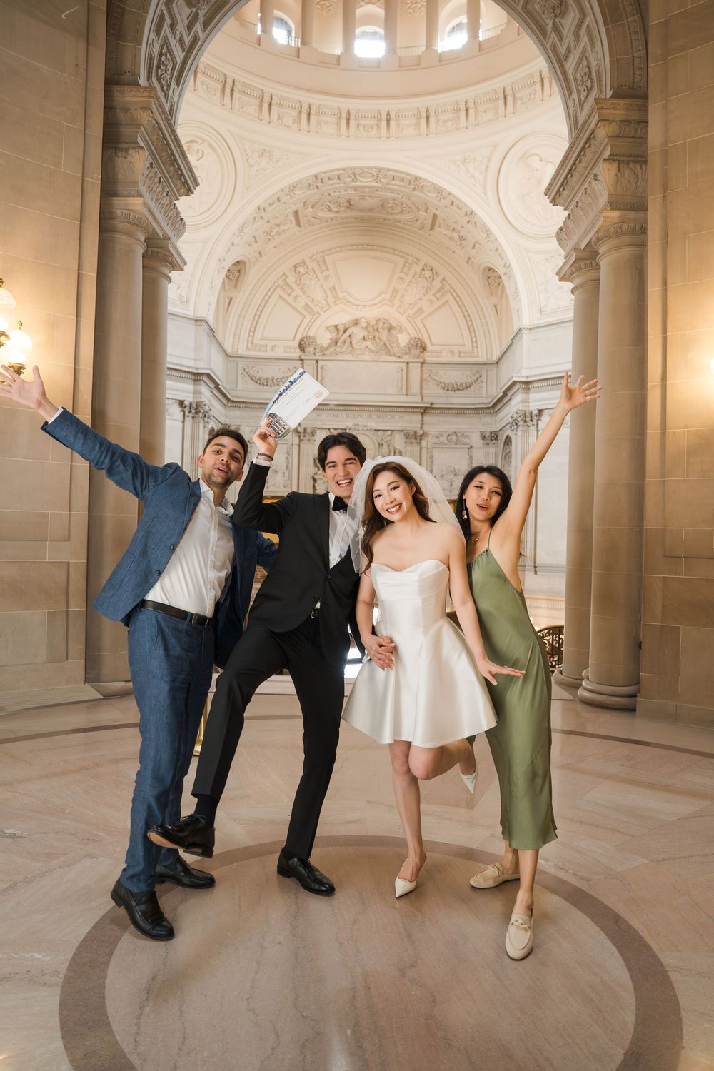 A fun photo sequence showing a group posing playfully in different poses at San Francisco City Hall's grand interior.
