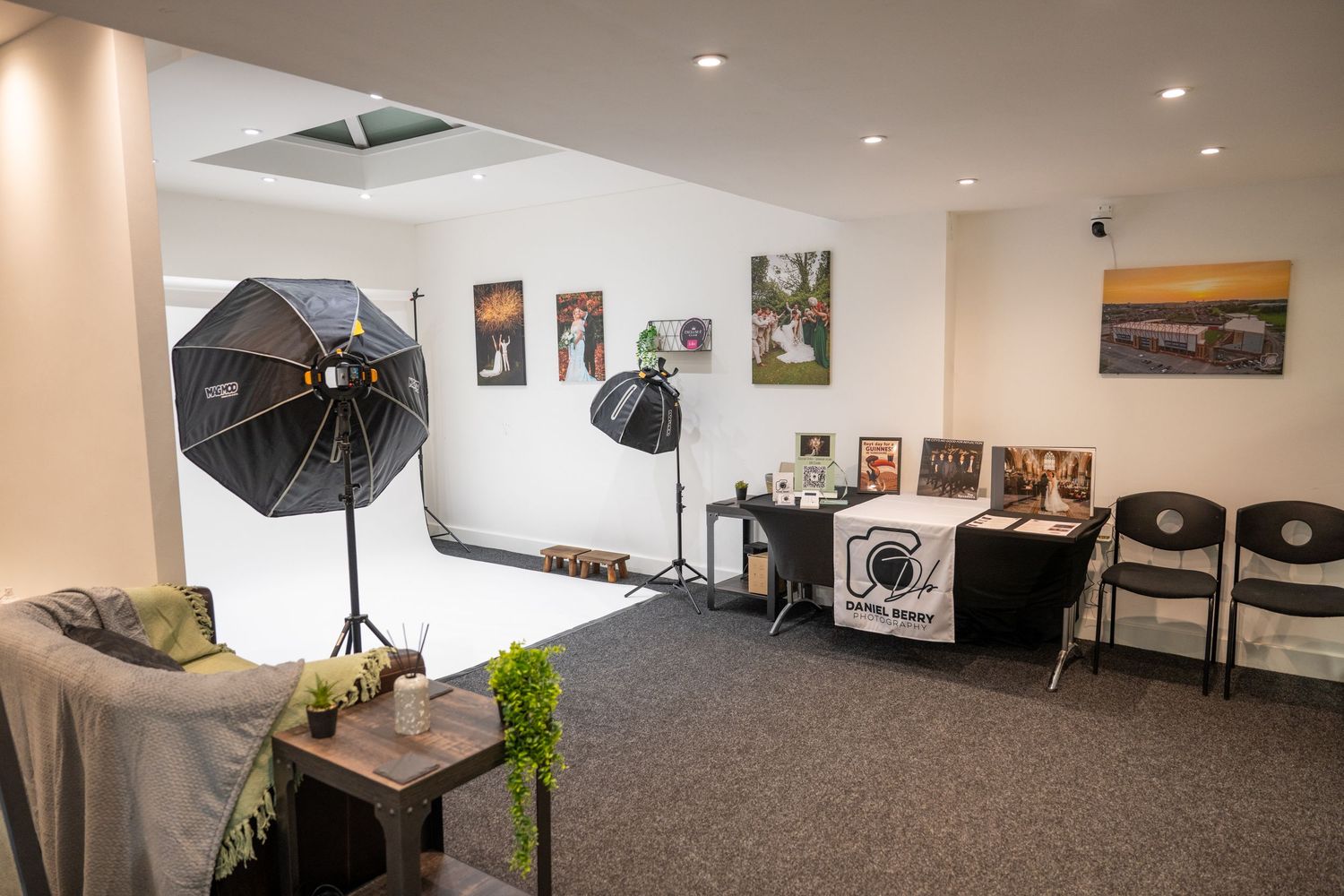 Modern photography studio in barnsley with white walls, lighting equipment, and artwork displays along the walls. Daniel berry Photography