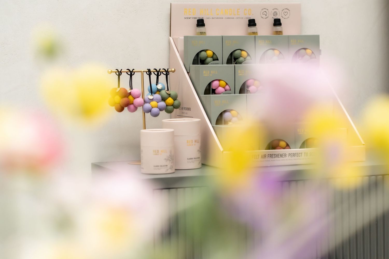 Retail display shelves showcasing beauty products, perfumes, and skincare items in a boutique store setting.