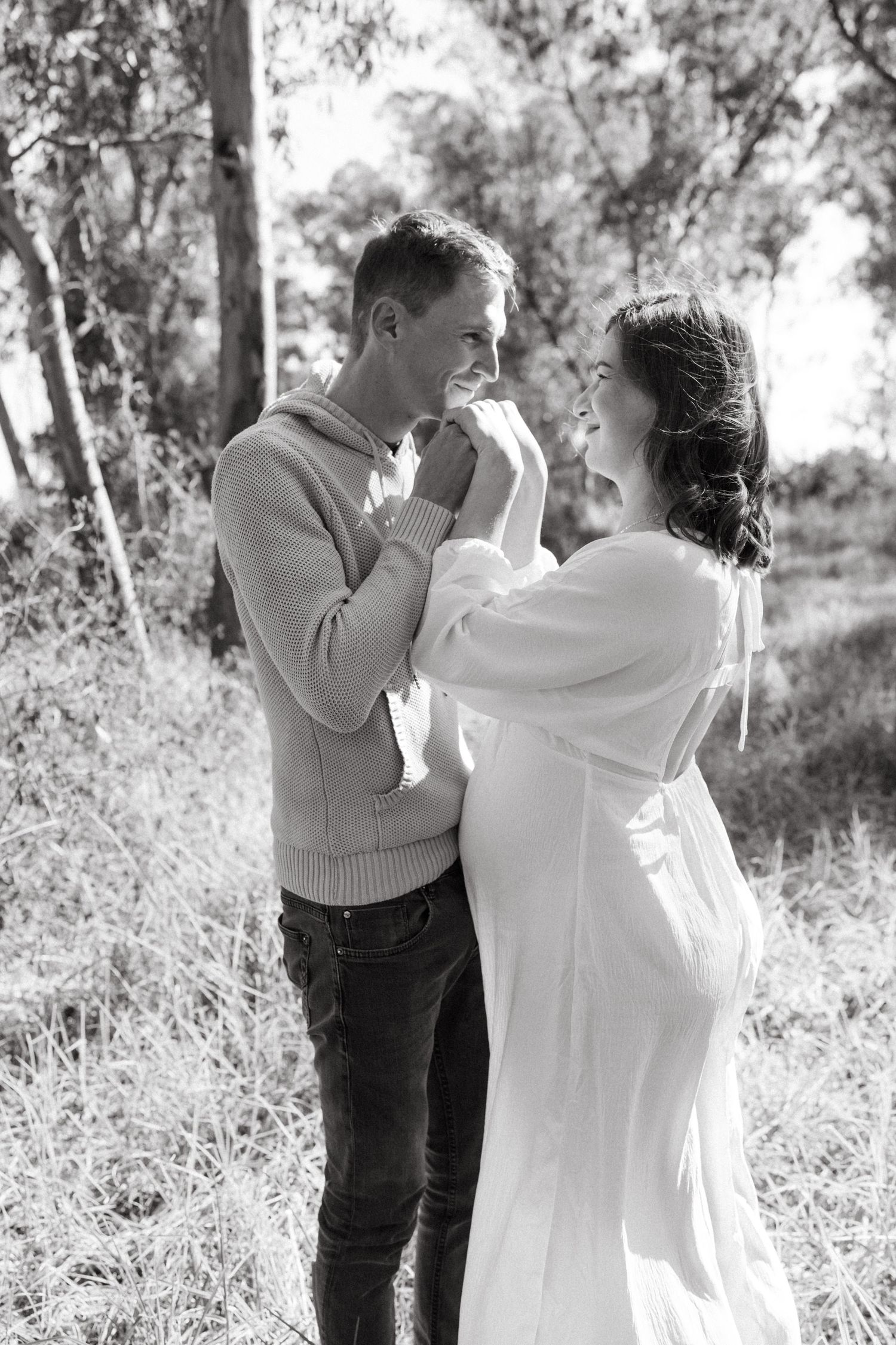 Black and white romantic portraits of a couple dancing in a natural outdoor setting.