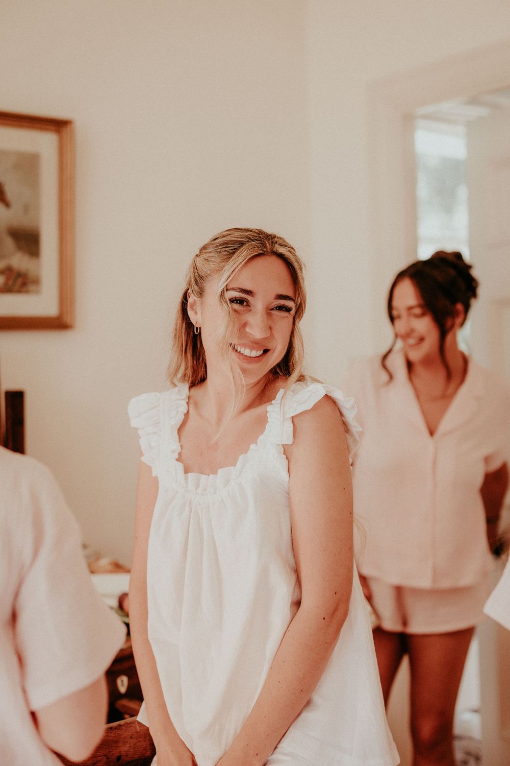 A series of candid moments showing people in white dresses and outfits preparing for a special occasion.