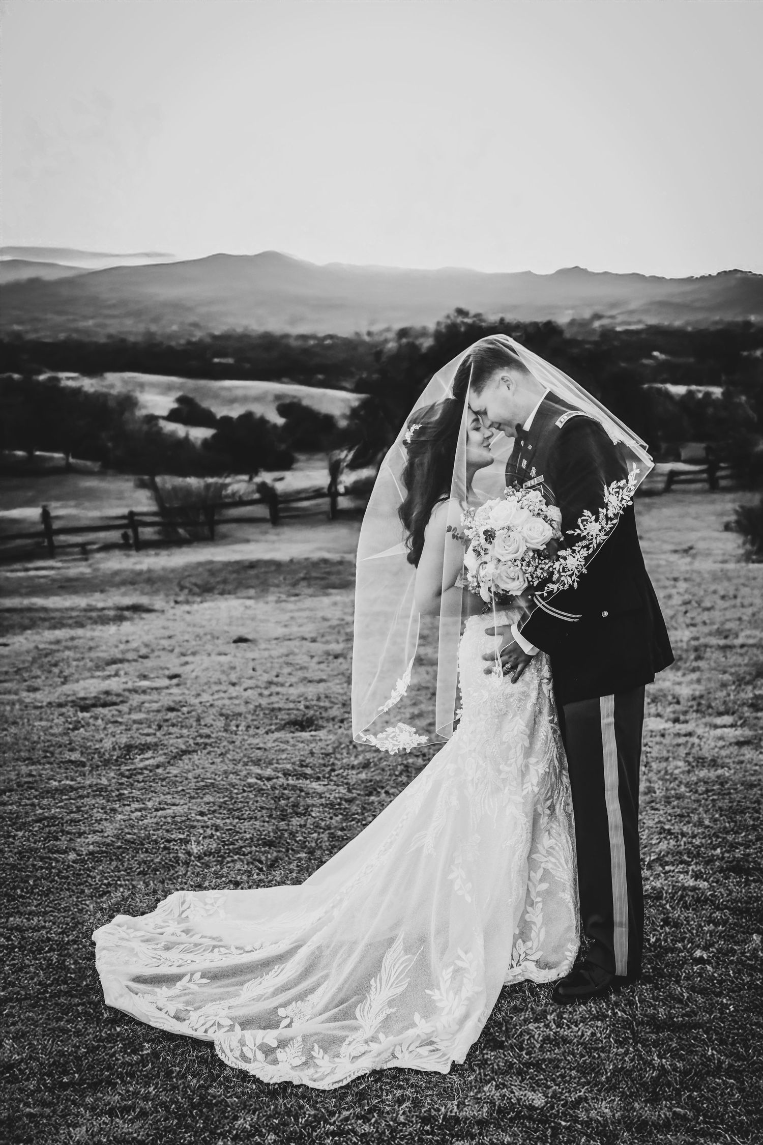 Romantic shot of bride and groom silhouetted in golden-hour light on the ranch.