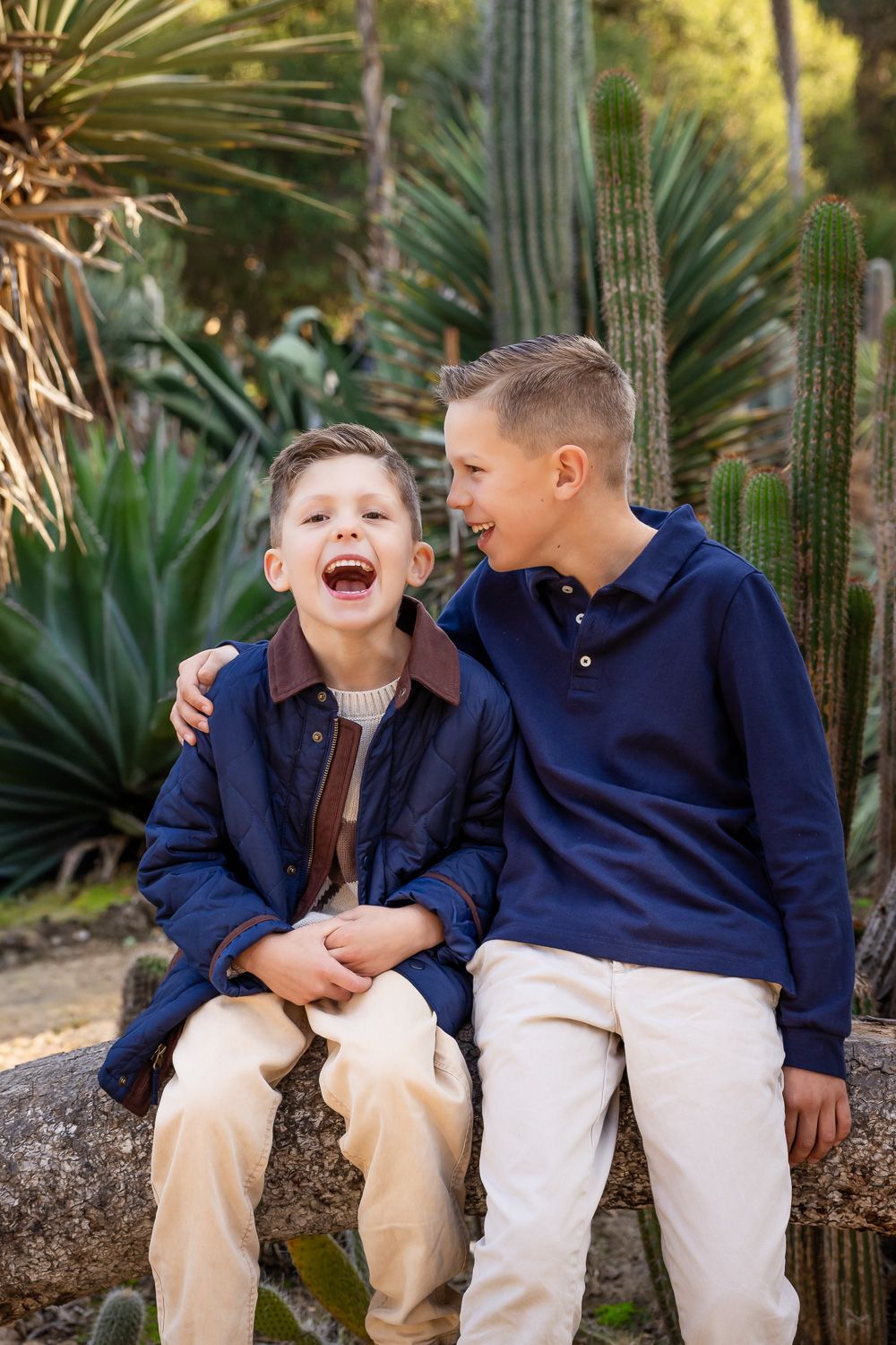 A child laughs as his older brother tells him a funny secret during their photoshoot in the Bay Area