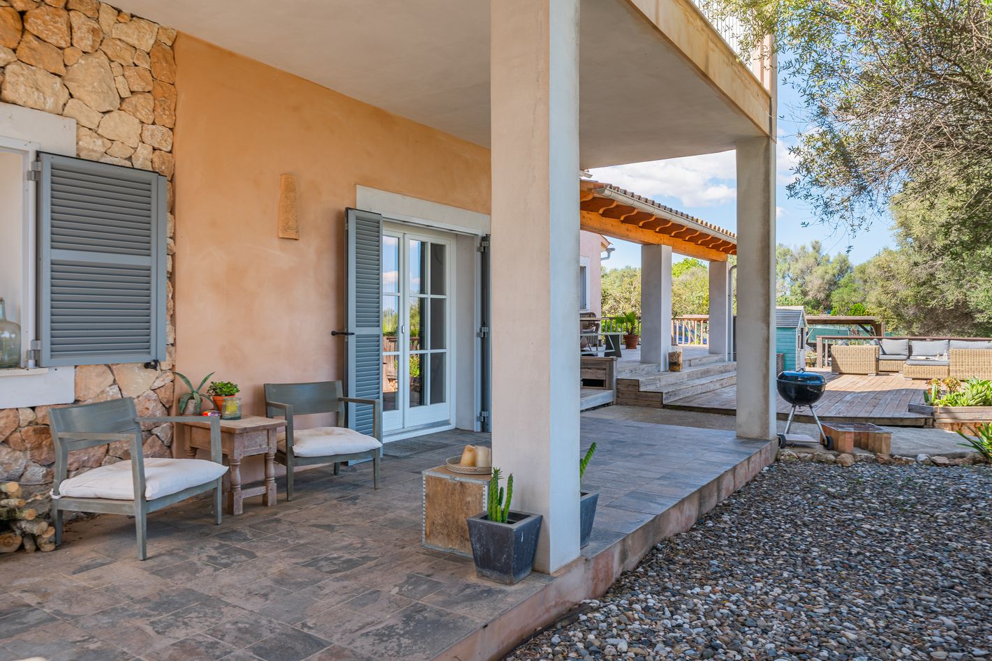 A collage of exterior views showing a covered porch with stone accents and gravel landscaping around a residential home.