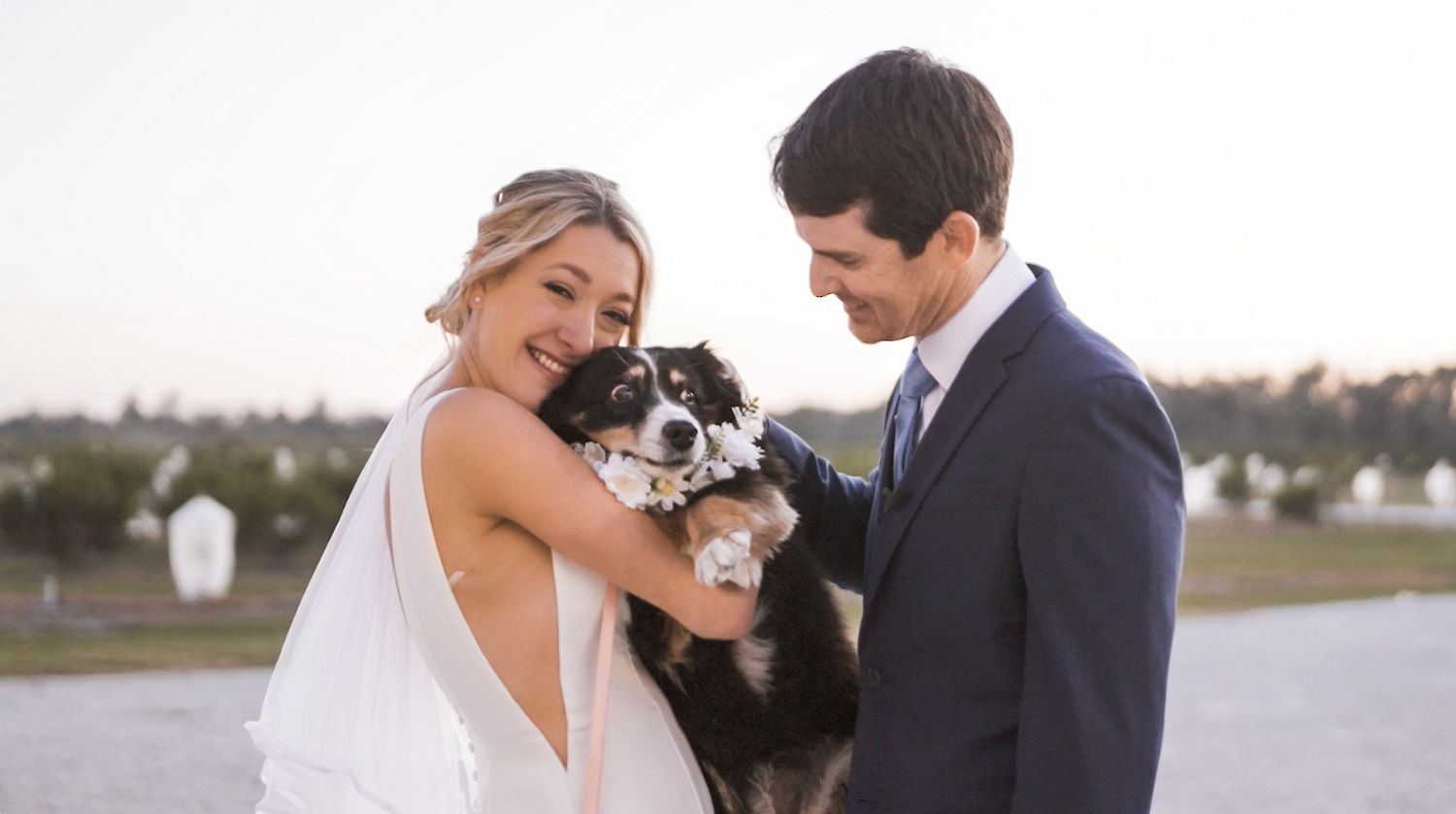 A wedding couple shares intimate moments during their outdoor photo session at sunset.