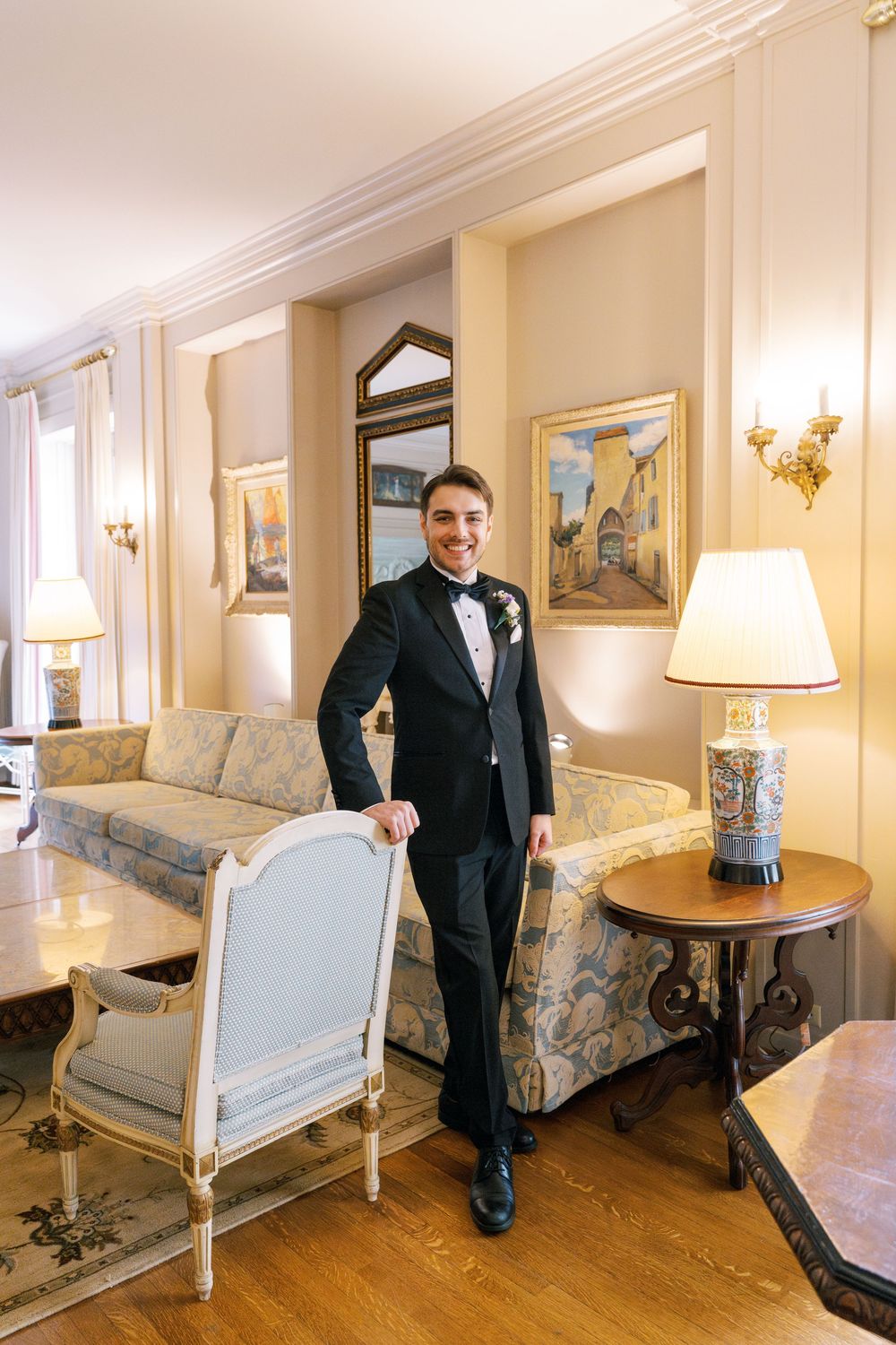 Elegant sitting room with antique furniture and hardwood floors in a wedding venue.