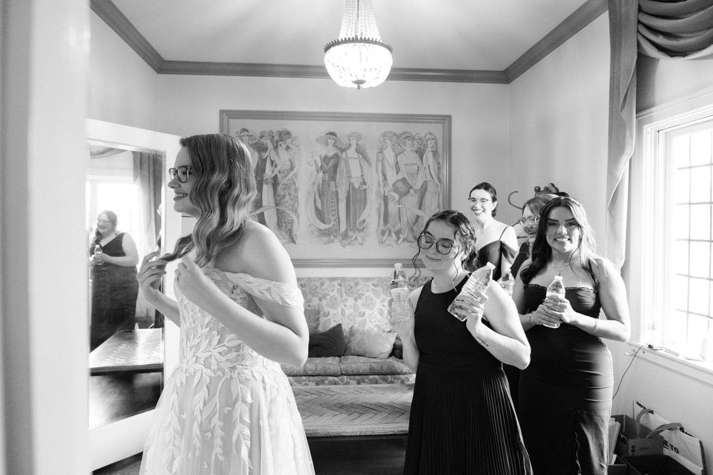 Getting ready moments captured in black and white during wedding preparations.