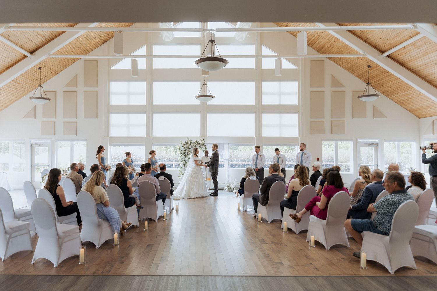 bride and groom holding hands during intimate wedding ceremony at Douglas Hazen Centre, Oromocto New Brunswick wedding Photographer near me