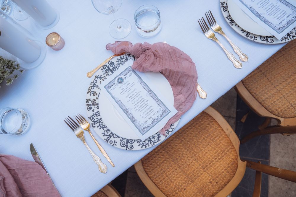 Elegant table setting with white plates and decorative details at a formal event.