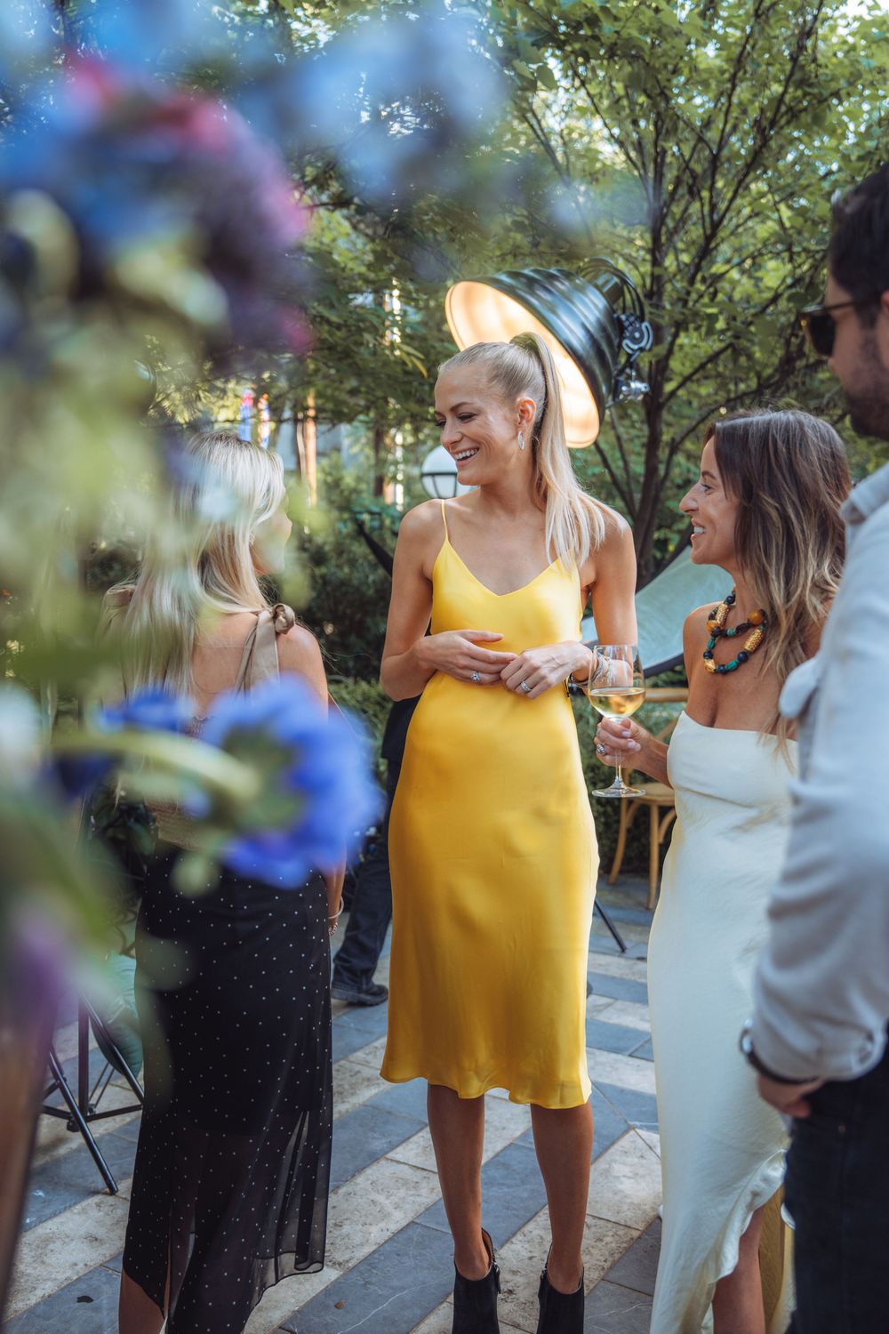 Wedding party members gathered outdoors in summer attire.