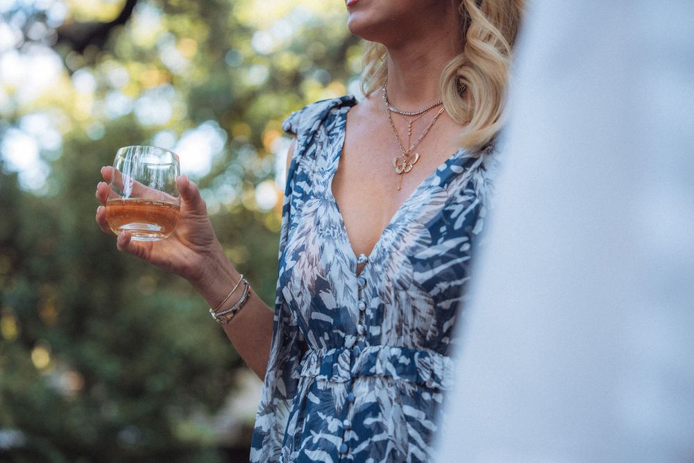 Guest enjoying a cocktail at an elegant outdoor reception.