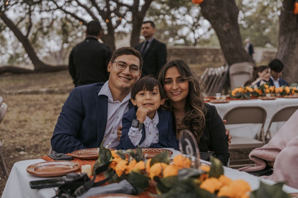 Guests enjoying conversation at an outdoor wedding reception with natural decor.