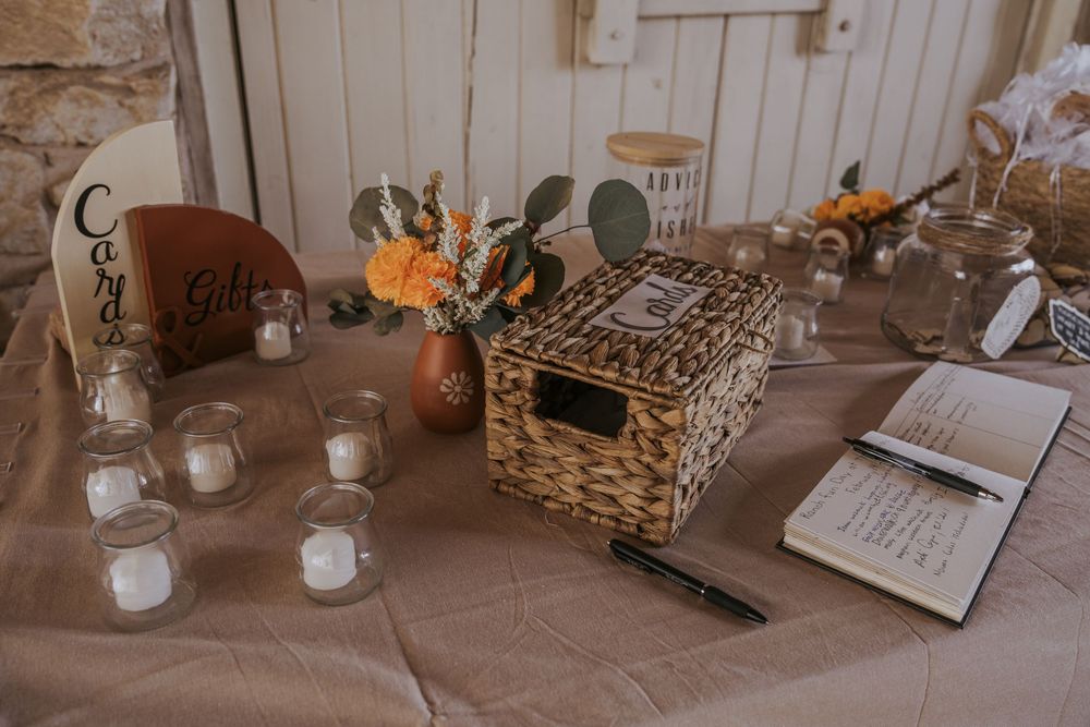 Elegant wedding reception table decor with candles and rustic white details.