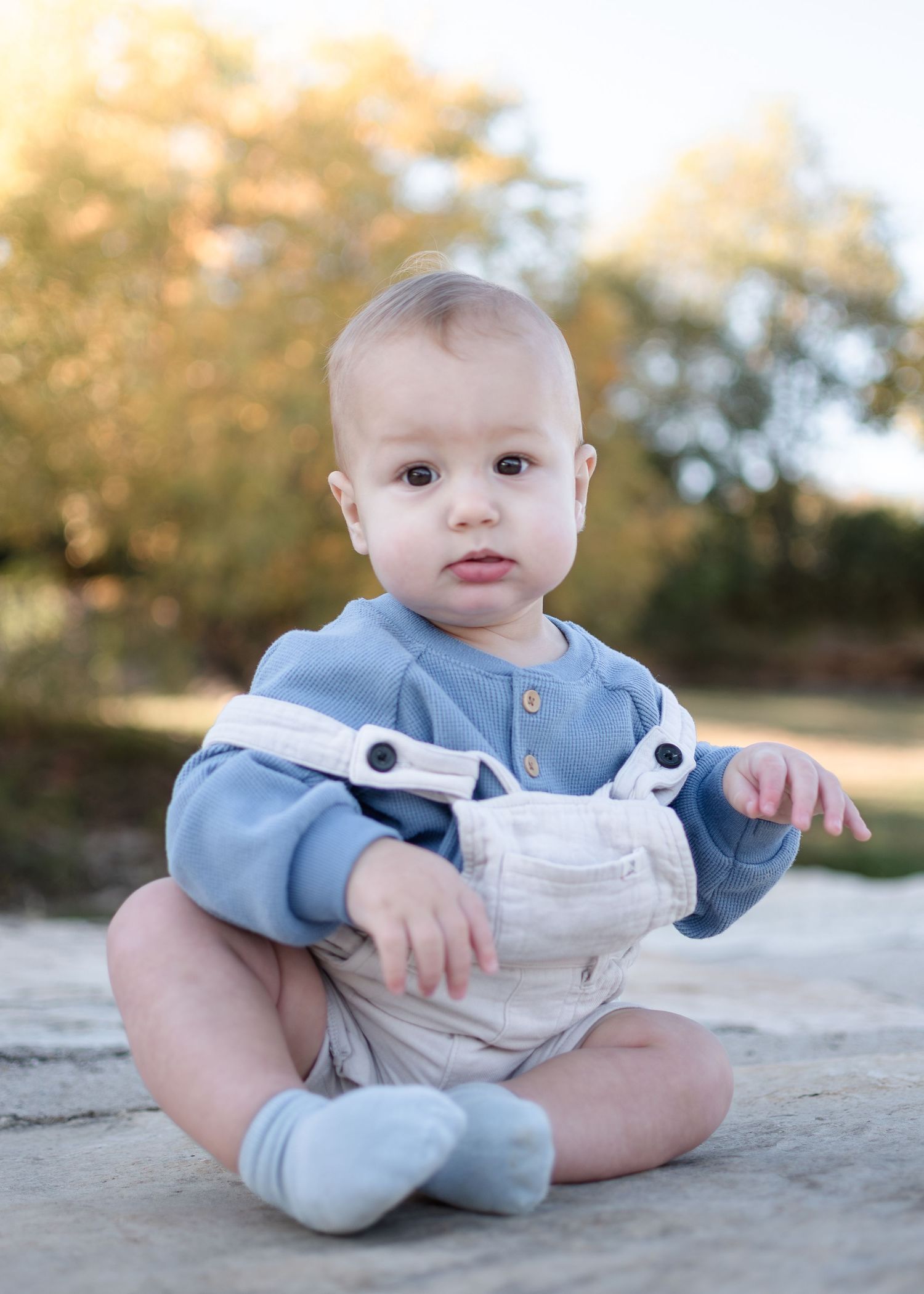 Baby sitting during outdoor family session at Nolan Creek in Belton Texas