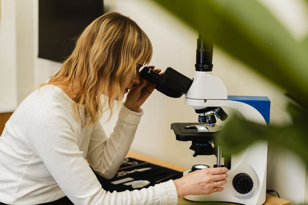 Jill conducting a scalp health check via microscope in her Eagle Rock studio photographed for her Los Angeles branding session.