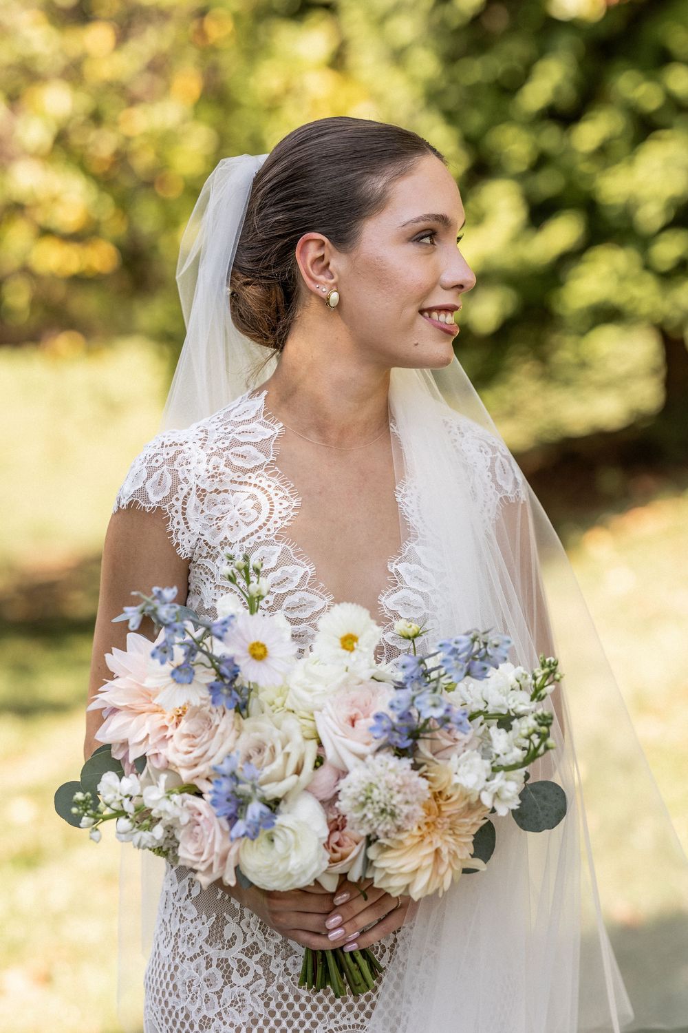Elegant bridal bouquet featuring soft pink and blue flowers with eucalyptus greenery.