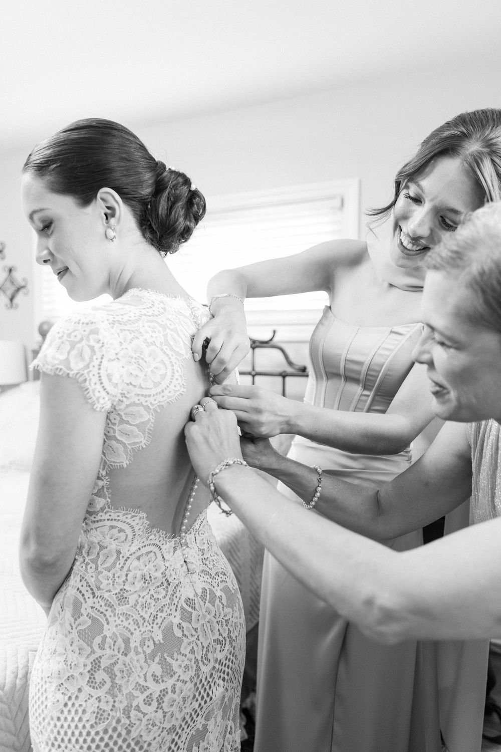 Series of photos showing the back of a lace wedding dress being buttoned up.
