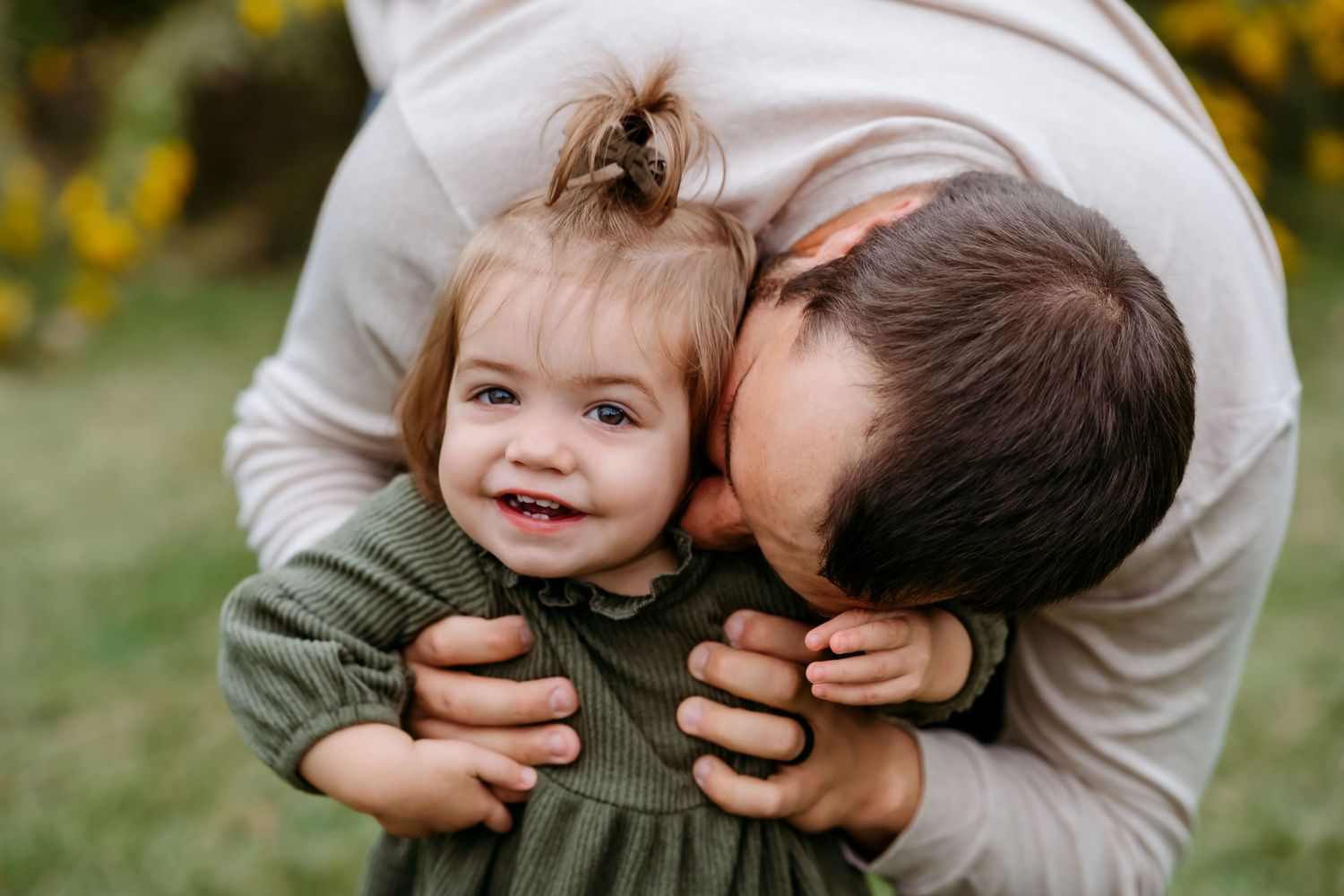 A series of playful candid photos showing joyful moments between a parent and child outdoors in nature.