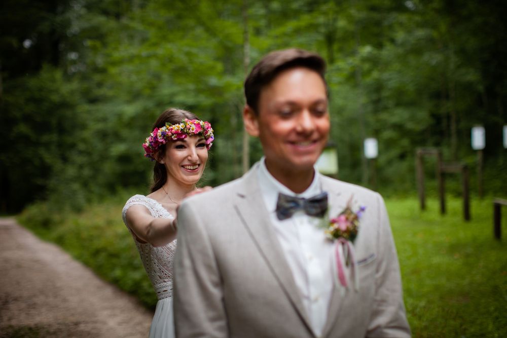 A romantic wedding photo sequence showing tender moments between newlyweds in a lush green forest setting.