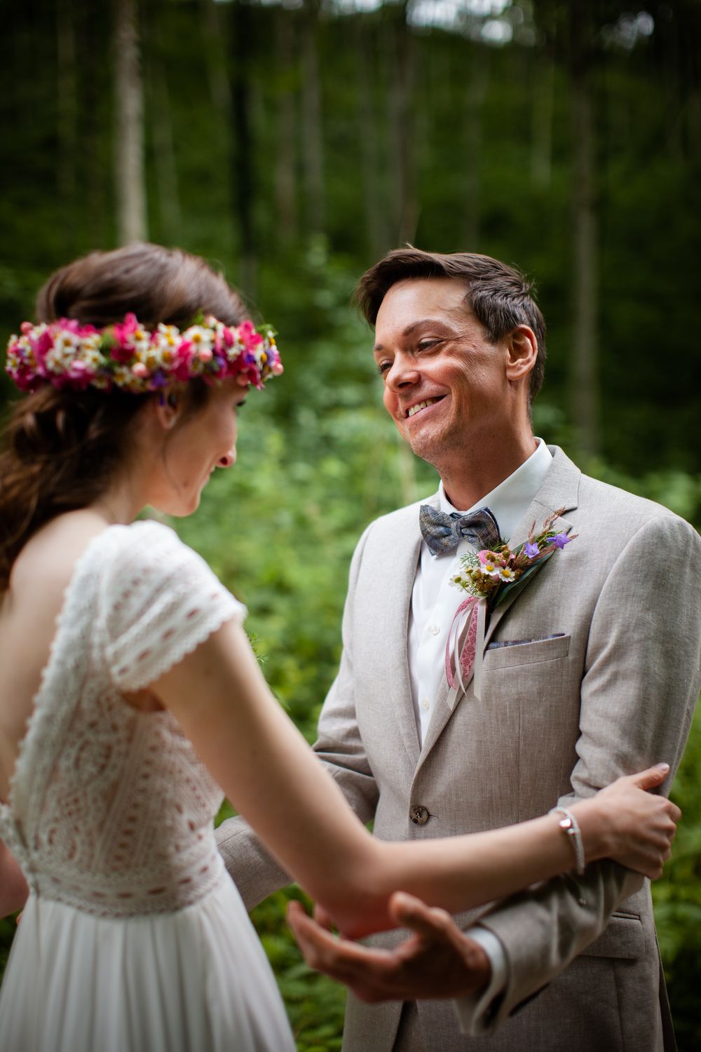 A sweet first look sequence between newlyweds in a lush garden setting.