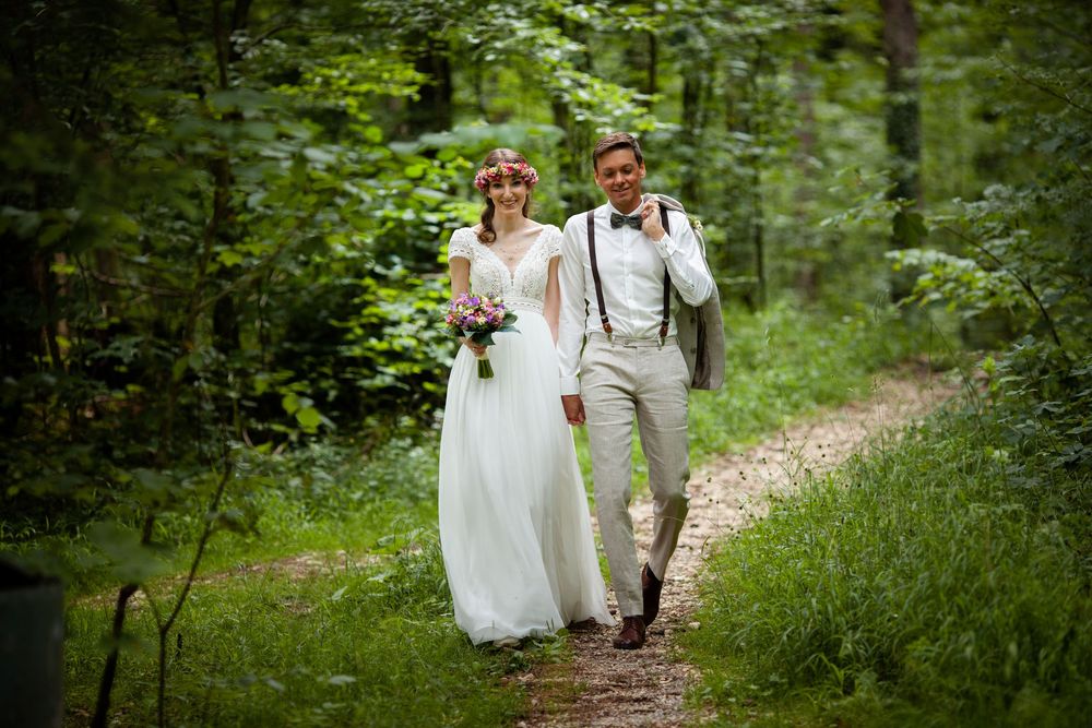 A series of wedding photos capturing the couple walking along a forest path surrounded by greenery.