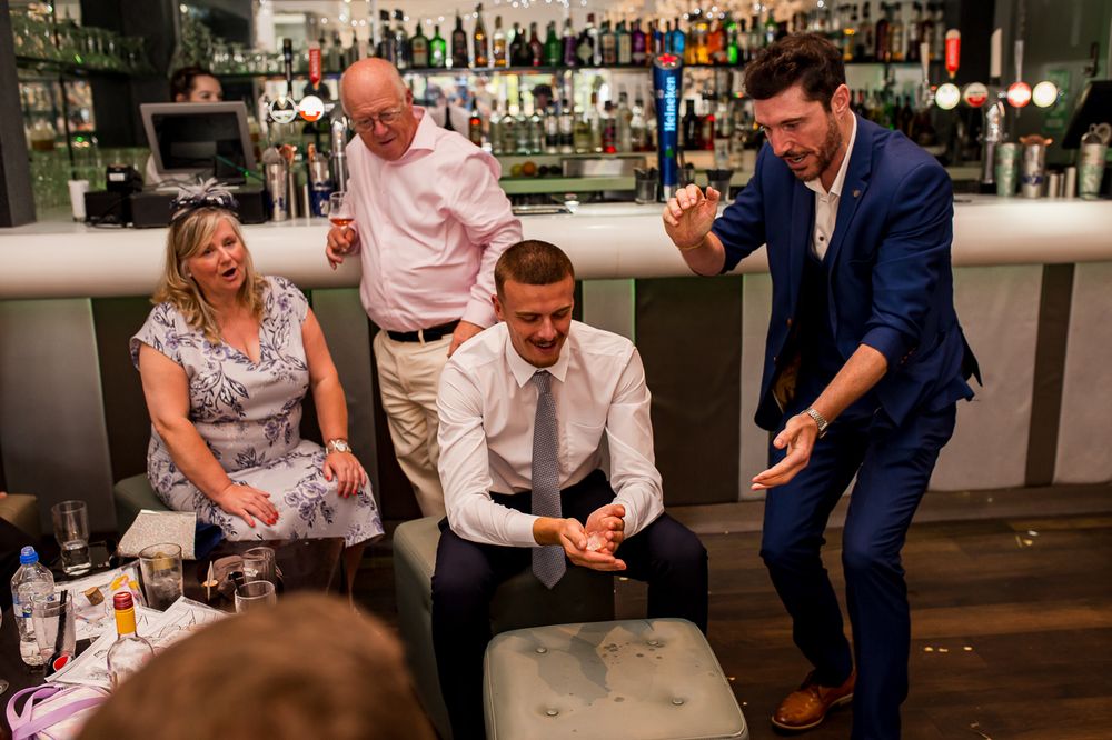 Wedding reception guests playing games at a bar counter.
