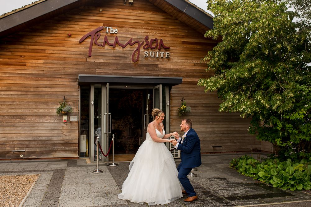 Romantic moment captured between couple at the entrance of The Paragon Barn wedding venue.