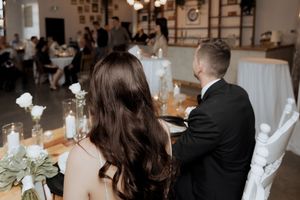 Bride and groom sitting at sweetheart table at Tire Shack Brewery Moncton wedding photography elegant black and white modern wedding portait