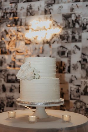 Black and white film vibes neon light cake display at Tire Shack Brewery, Moncton wedding photographer, Little Bear Bakery wedding cake