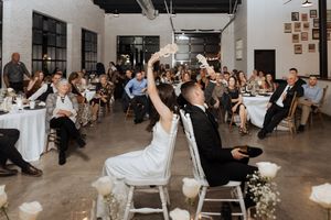 Bride and groom play the Shoe Game at Tire Shack Brewery Moncton wedding photographer New Brunswick modern elegant wedding design