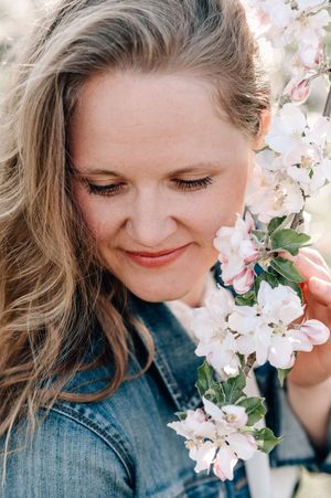 A series of springtime portraits with delicate white cherry blossoms against a teal blue background.