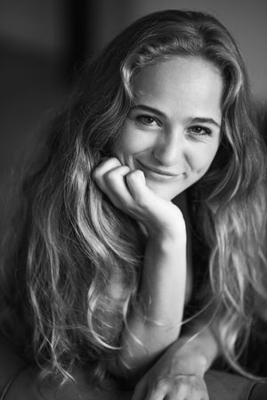 A black and white portrait series showing playful expressions and wavy hair against a dark background.