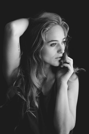 A series of black and white portraits showing a woman looking contemplative while resting her hand near her face.