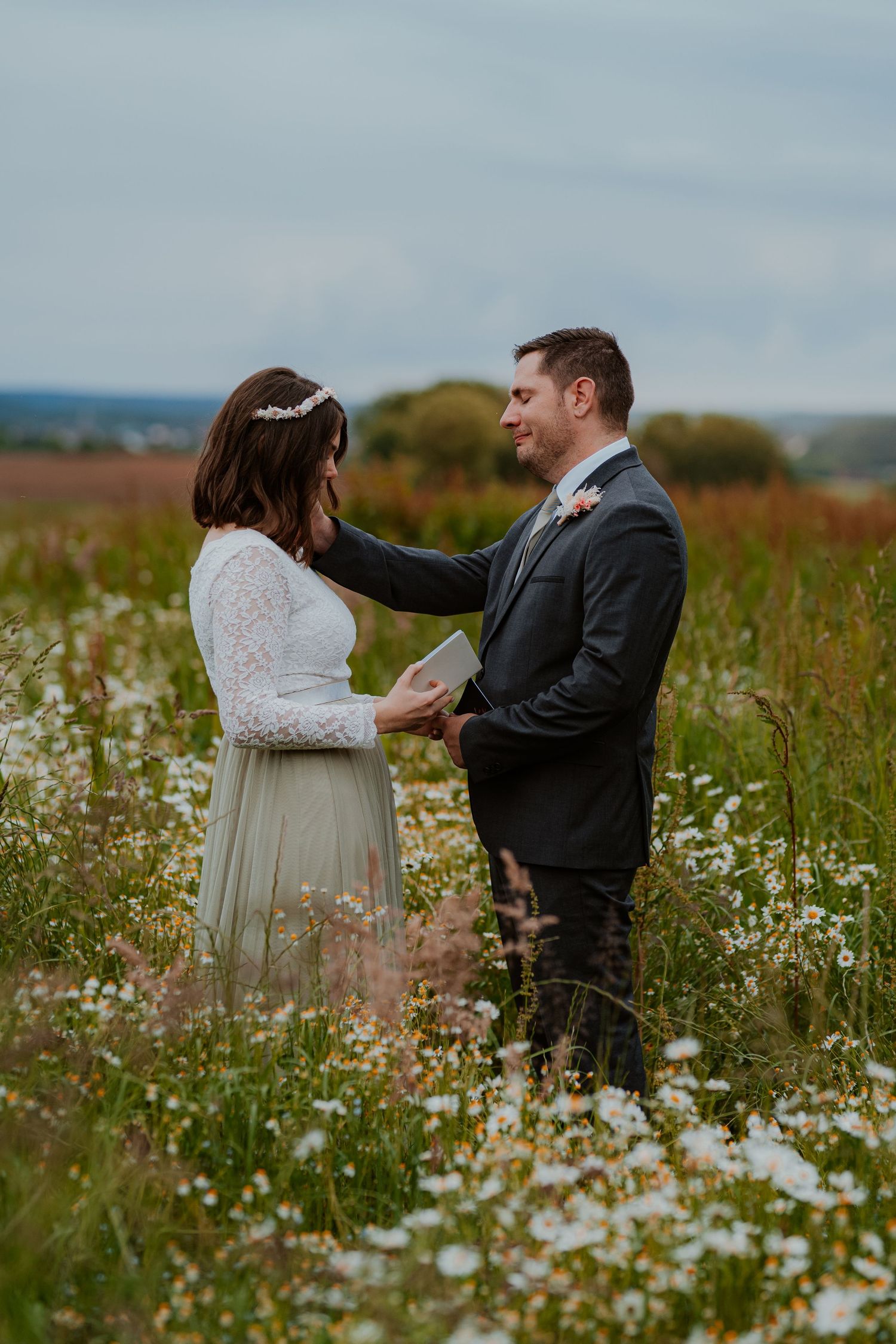 Intimate romantic couple sharing tender kisses in moody lighting with warm orange glow.
