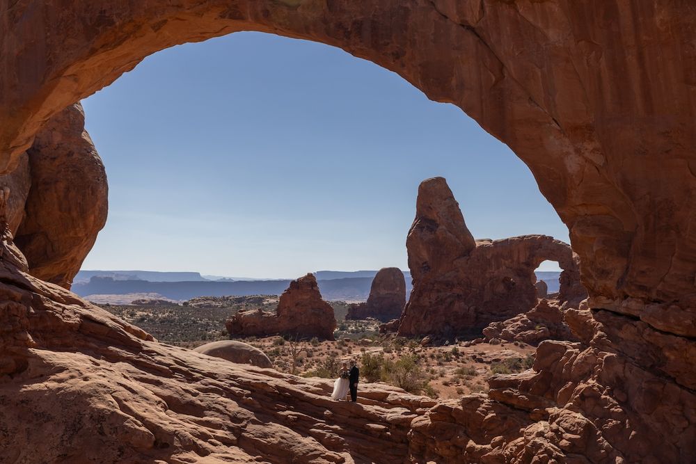Red rock formations and natural arches frame a scenic desert landscape at Arches National Park in Utah.