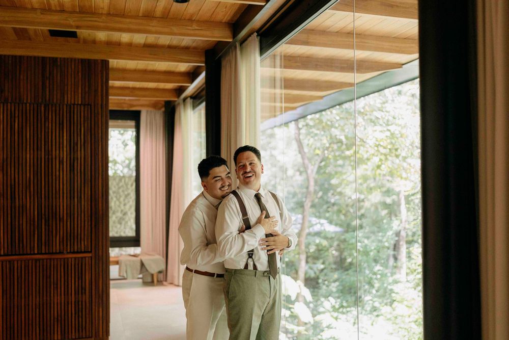 Candid laughter between couple before their same-sex wedding in Costa Rica.