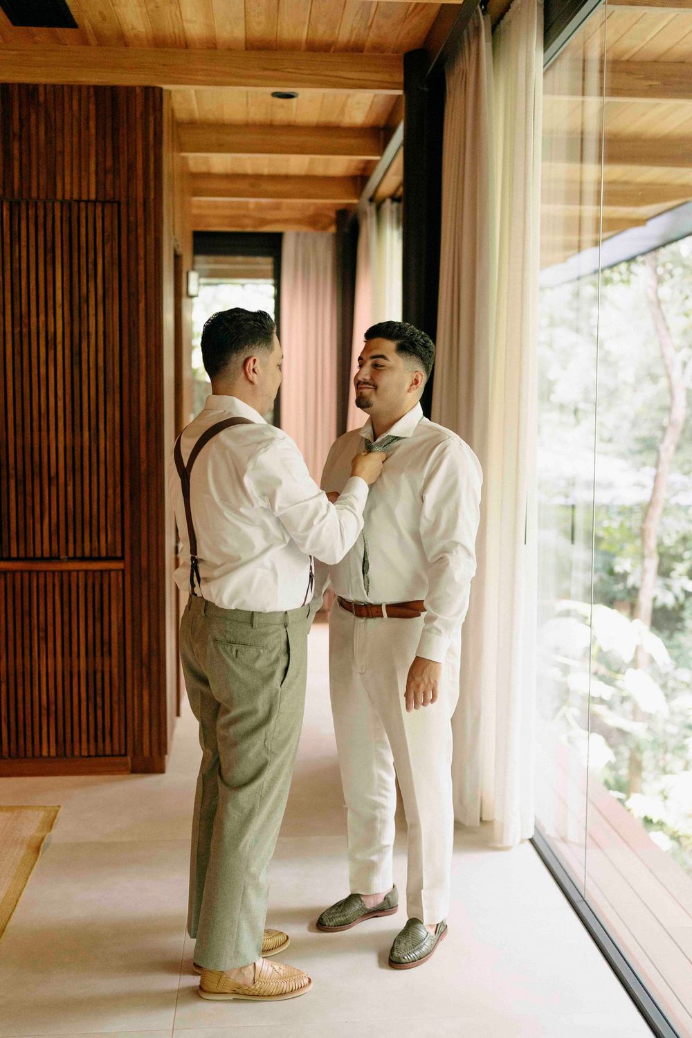 Groom adjusting boutonniere before ceremony at Rio Perdido Guanacaste.