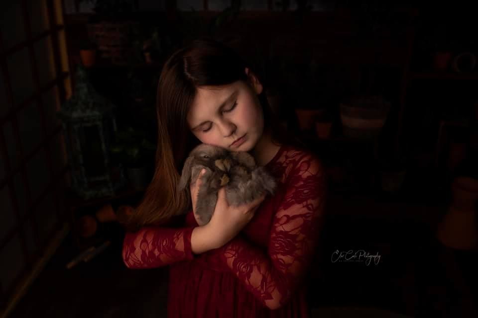 Dramatic portrait in deep red tones with moody lighting.