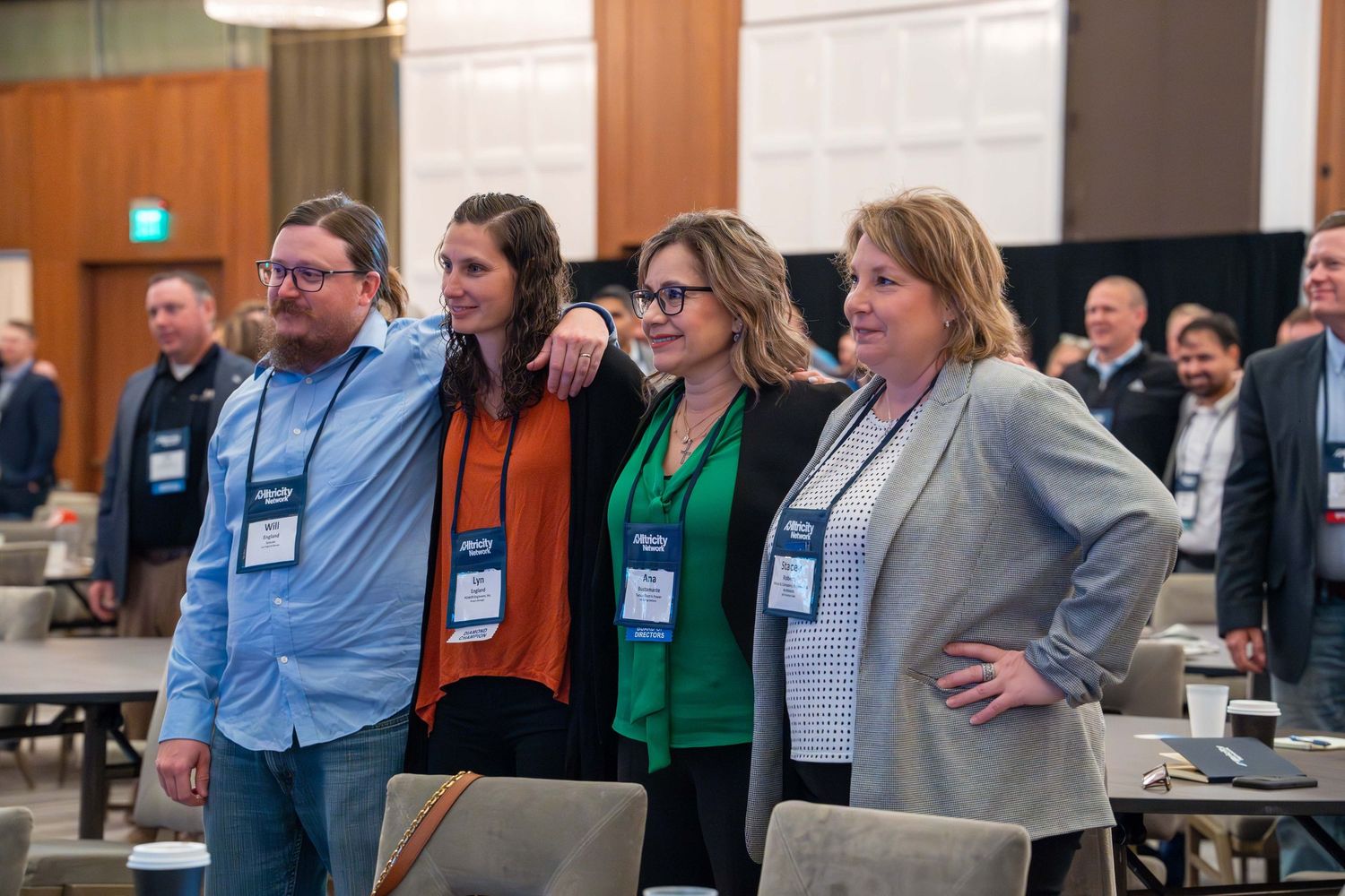 Business professionals engage in discussion during a conference session in a modern meeting room.