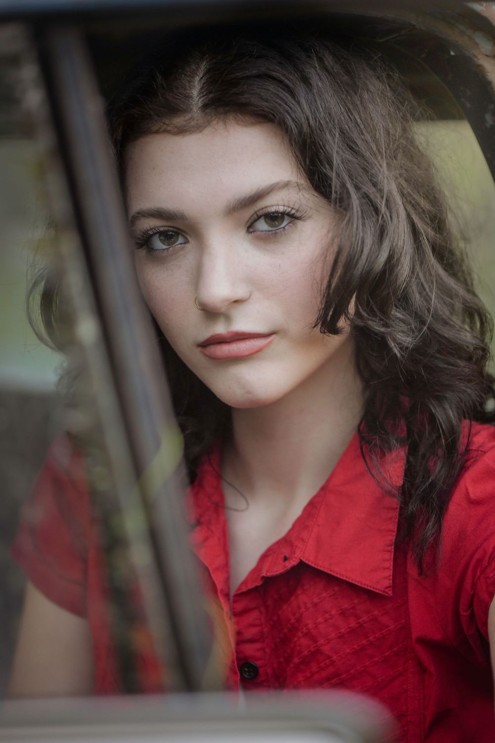 A photo sequence shows someone with long dark hair wearing a red blouse looking away and tilting their head thoughtfully.
