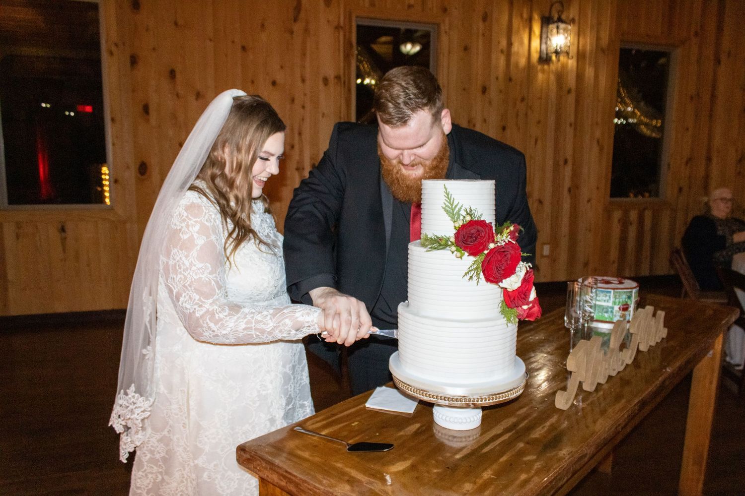 Wedding Photographer, Newlywed couple cuts wedding cake during wedding reception