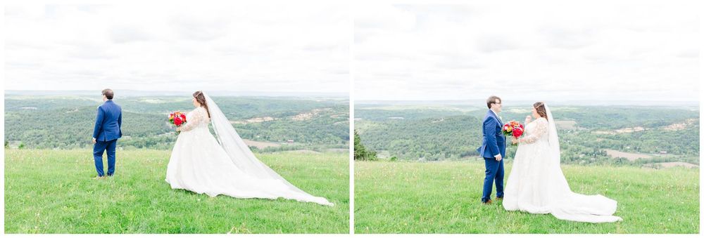 A couple shares a romantic moment on a hilltop overlooking a scenic countryside landscape on their wedding day.