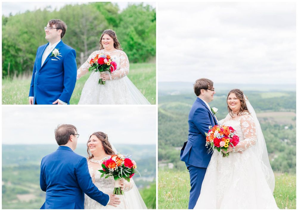 A newlywed couple celebrates their wedding day on a scenic hilltop with vibrant spring flowers and rolling hills in view.