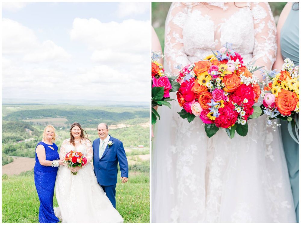 Vibrant pink and orange floral bouquets pop against blue and white attire at an outdoor wedding with rolling hills backdrop.