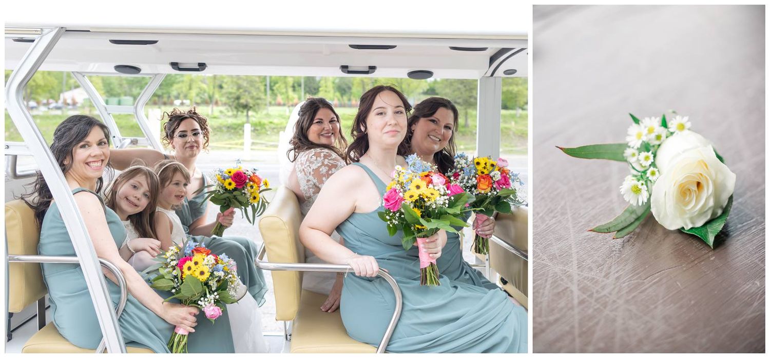 A wedding party in light blue dresses sits together holding vibrant orange and pink floral bouquets.