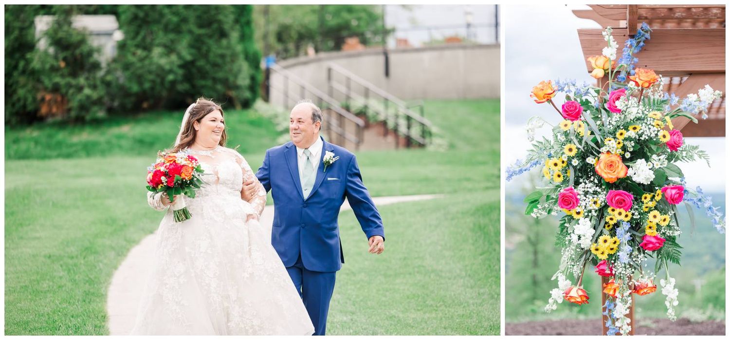 A joyful couple walks hand in hand on a garden lawn alongside a colorful floral bouquet arrangement.