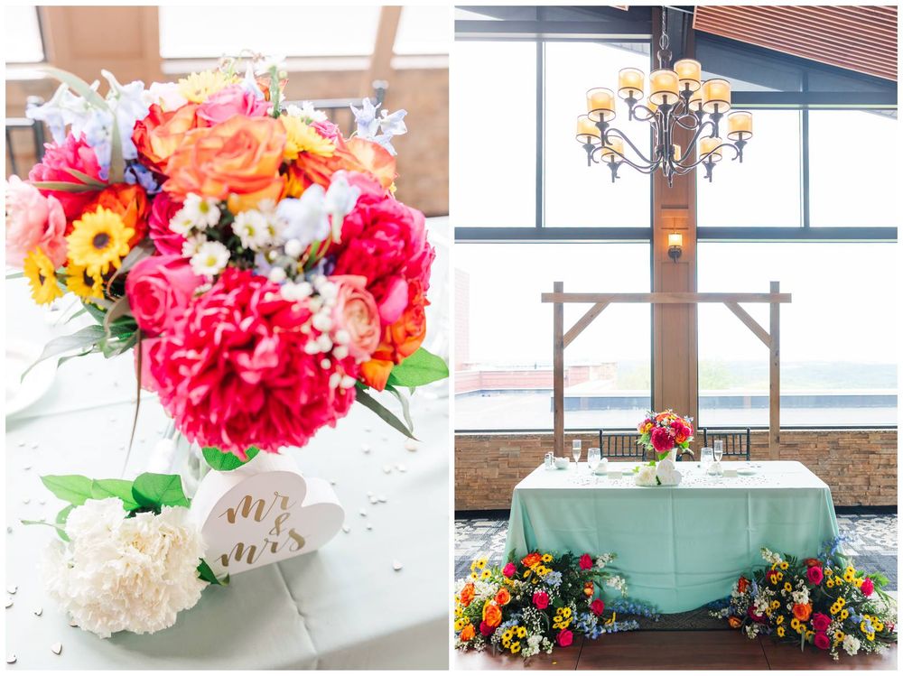 A bright floral arrangement in pink and orange sits on an end table beside an elegant altar setting with a mint tablecloth.