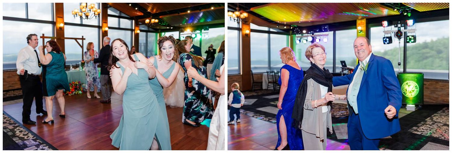 People dance and celebrate together on a scenic boat cruise venue with panoramic windows and colorful lighting.