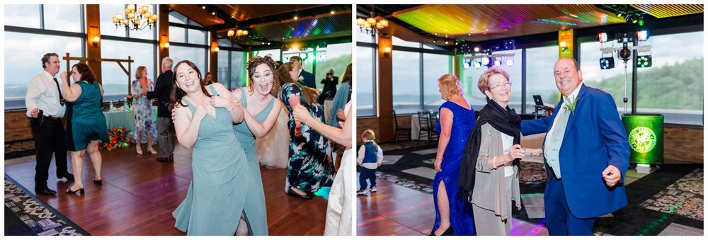 People dance and celebrate together on a scenic boat cruise venue with panoramic windows and colorful lighting.