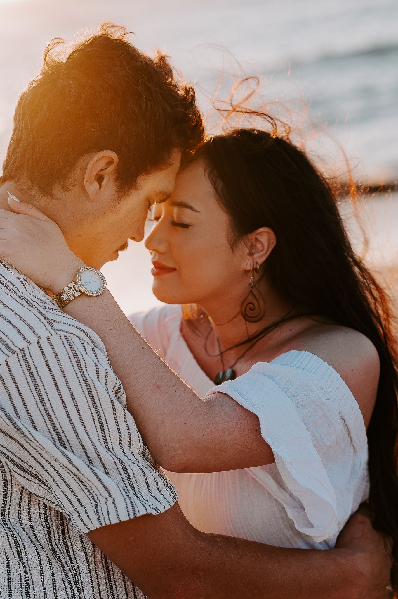 A romantic sunset sequence shows a couple embracing and kissing on the beach in warm golden sunlight with Story and Soul Photo Mandurah WA